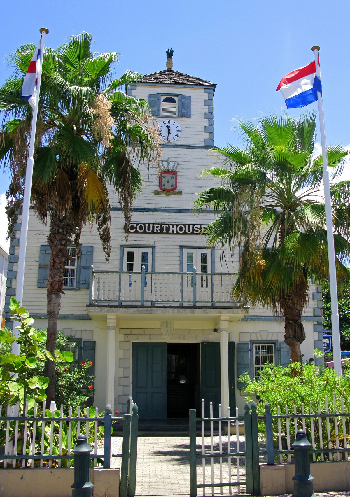 Historic white courthouse in Philipsburg with Dutch and Sint Maarten flags