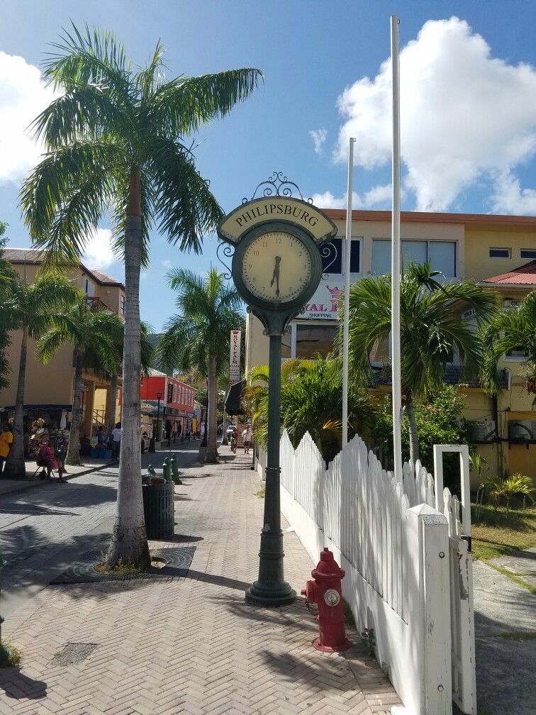 Philipsburg clock landmark on Front Street with palm trees