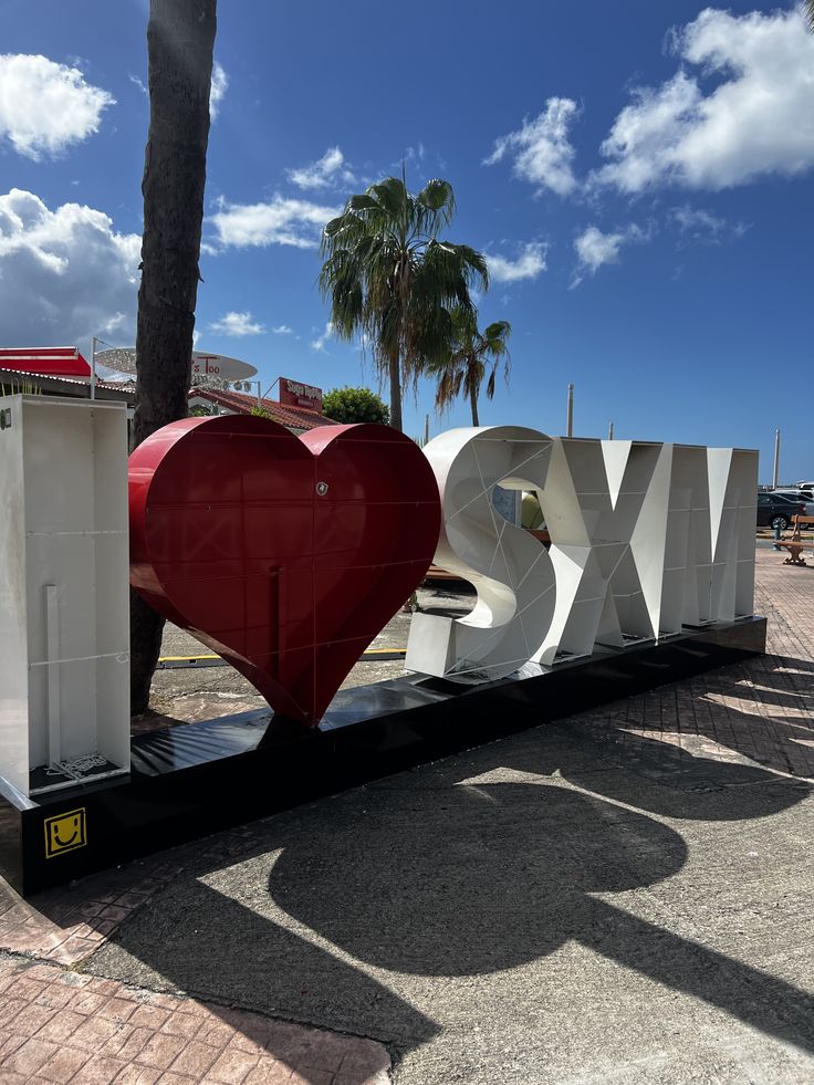 I Love SXM sign with palm trees and blue sky in Sint Maarten
