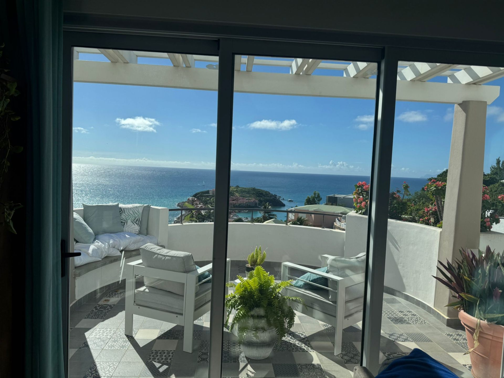 Terrace overlooking the turquoise water and hills of Sint Maarten