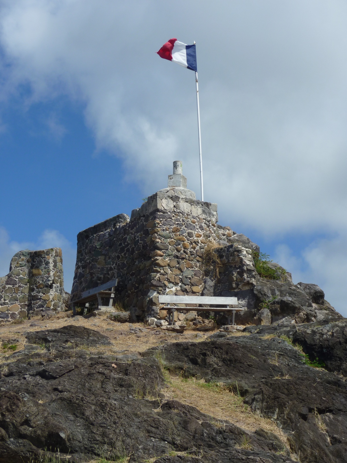 Stone ruins of Fort Louis with the French flag flying above Marigot