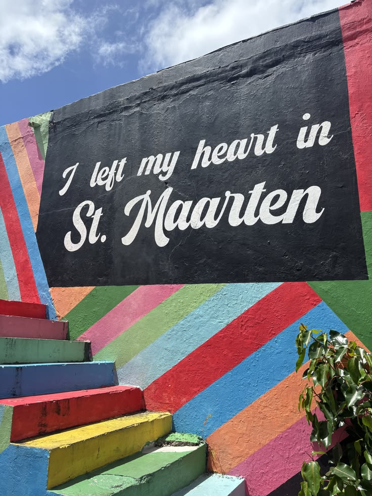 Colourful painted steps and mural reading I left my heart in St. Maarten