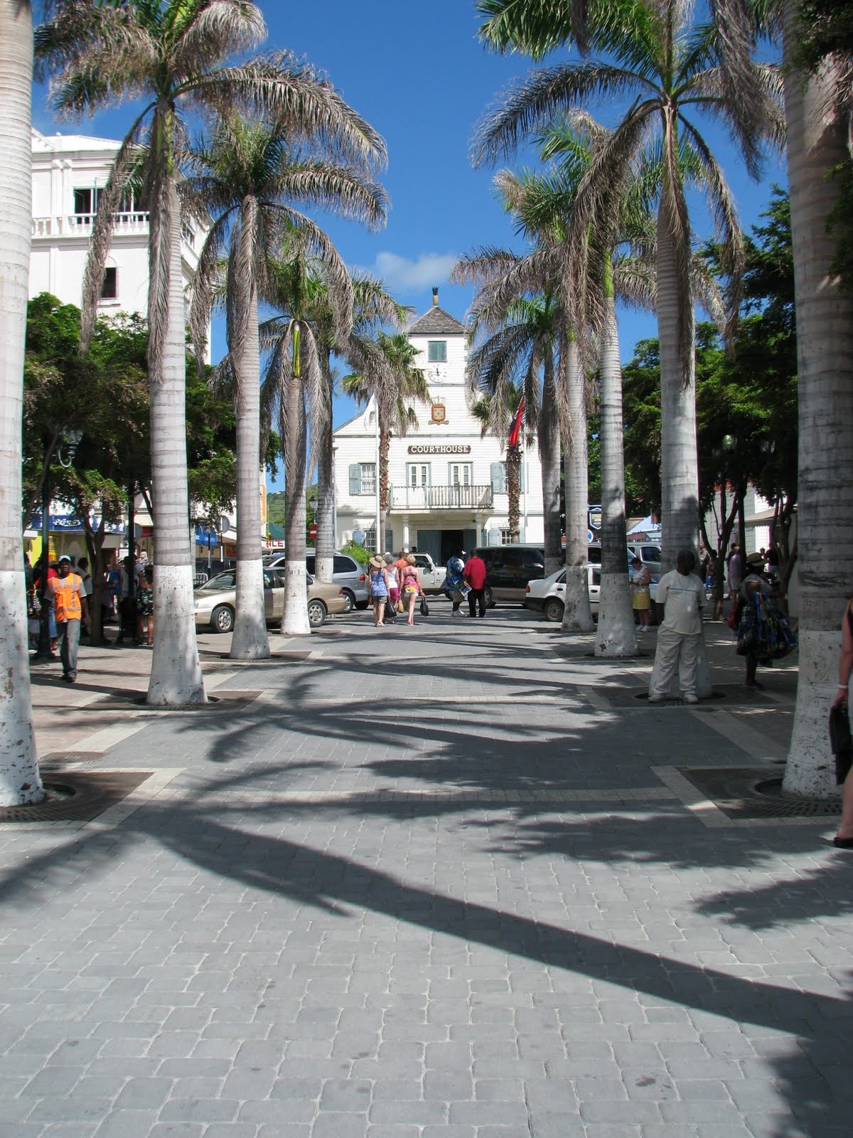 Historic white courthouse in Philipsburg framed by tall palm trees