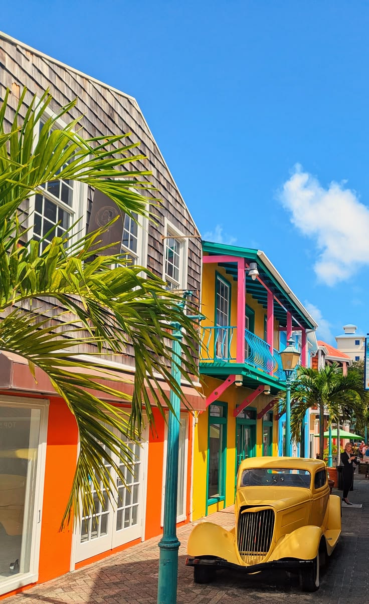 Colourful historic buildings and a vintage yellow car in Philipsburg old town