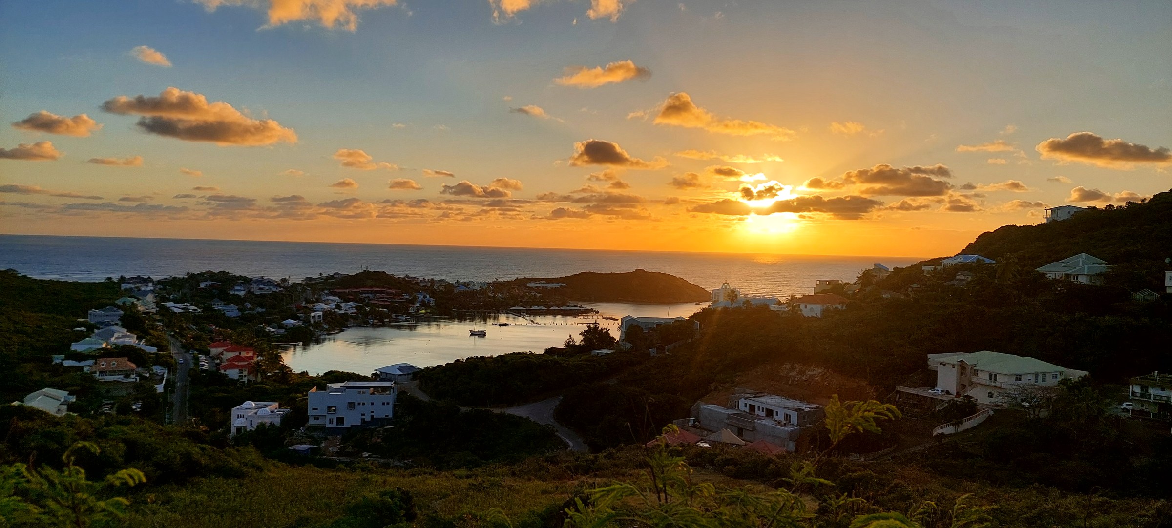 Sunrise light spilling over a bay in Sint Maarten