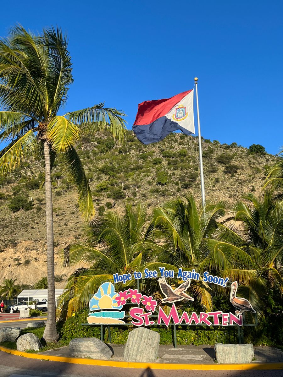 St. Maarten welcome sign and national flag at the airport roundabout